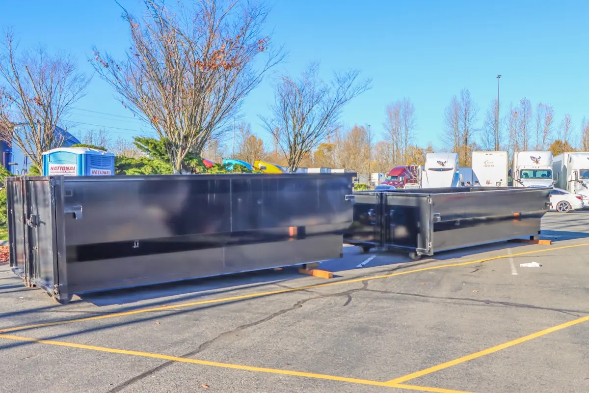 Professional dumpster rental service with roll-off container on residential driveway in Willowbrook